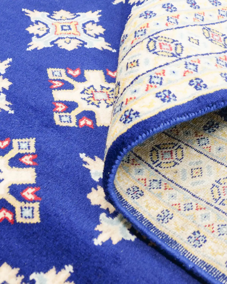 ネイビー地に二種類のひし形模様が規則的に並んだラホール産手織りパキスタン絨毯