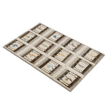 12の枠に動物や木のモチーフを織り込んだギャッベ