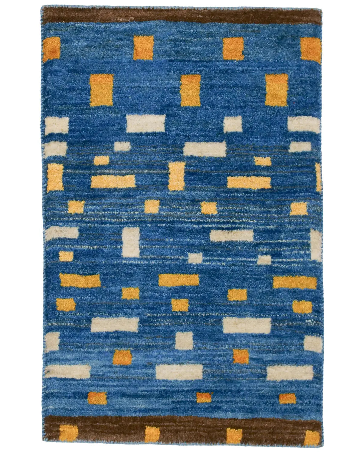 深い青地に黄色と白のブロック模様が並ぶモダンギャッベ