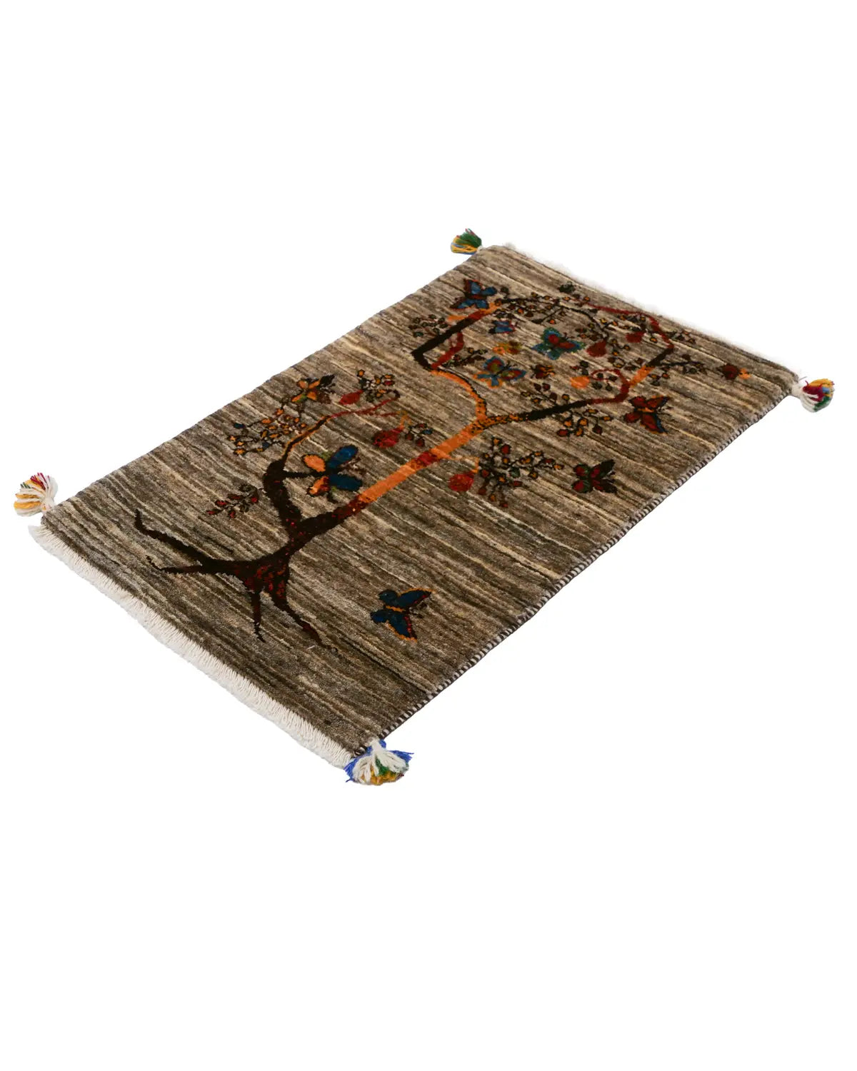 落ち着いたグレー地にオレンジの幹が映える美しいギャッベ