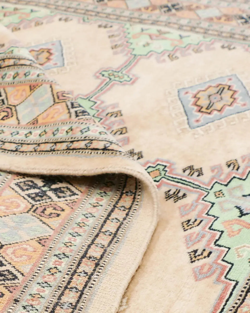 ベージュと淡いグリーンを基調とした幾何学模様が特徴のラホール産パキスタン絨毯