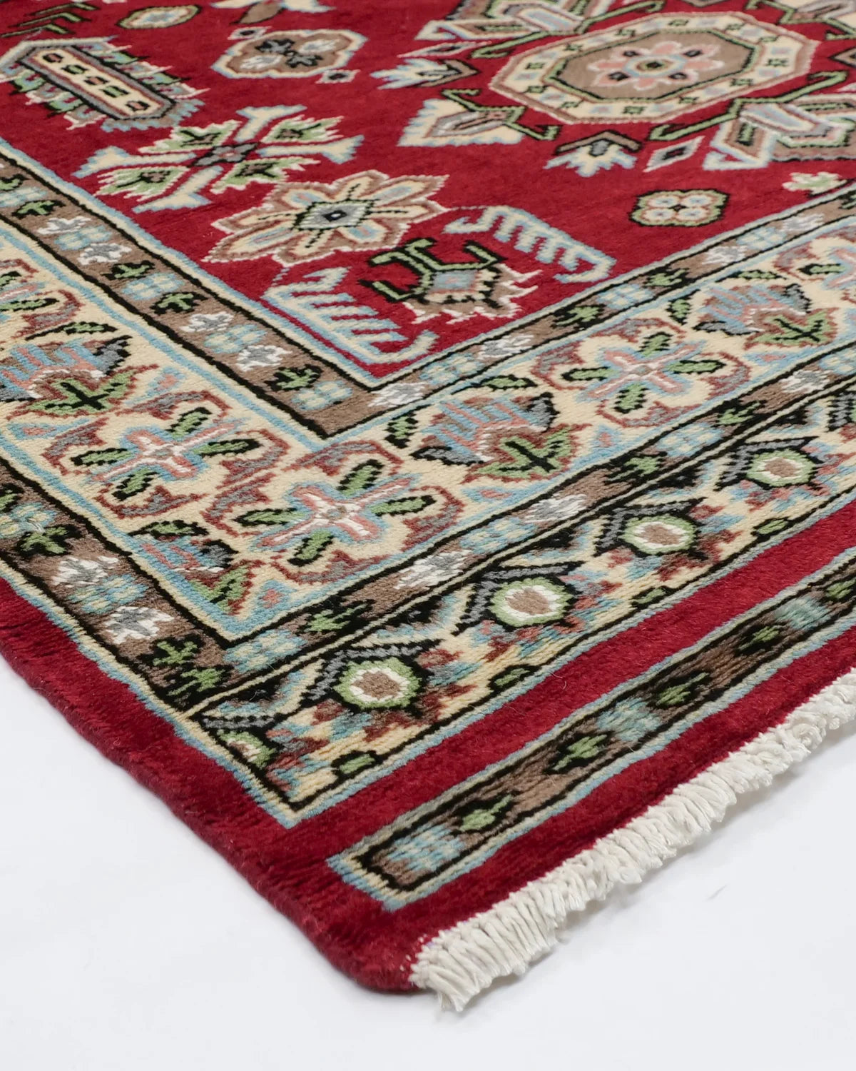 アイボリーの縁取りが映える、深紅のパキスタンウール絨毯